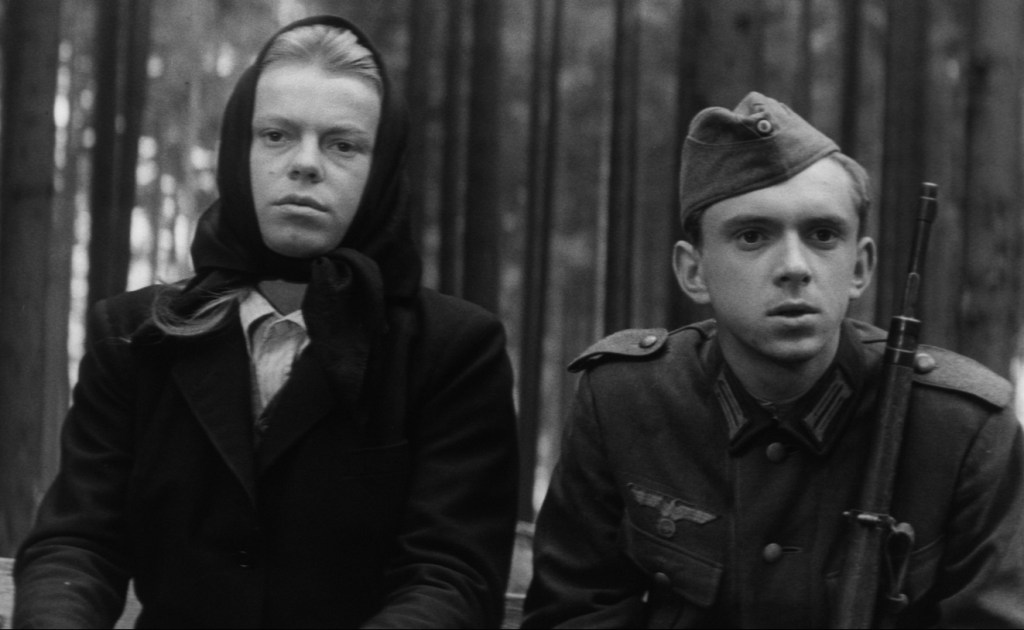A grieving widow riding next to a German soldier on a horse-drawn cart in Coach to Vienna
