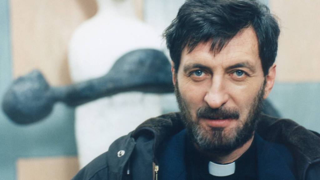 Bolek Polívka as doubting priest Father Holy in Forgotten Light