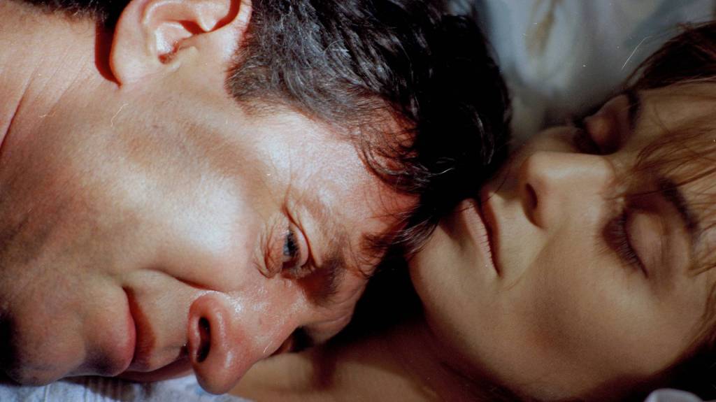 Father Holy comforting a dying woman in Forgotten Light