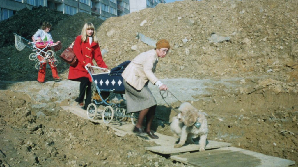 Residents struggle through the rubble in Prefab Story