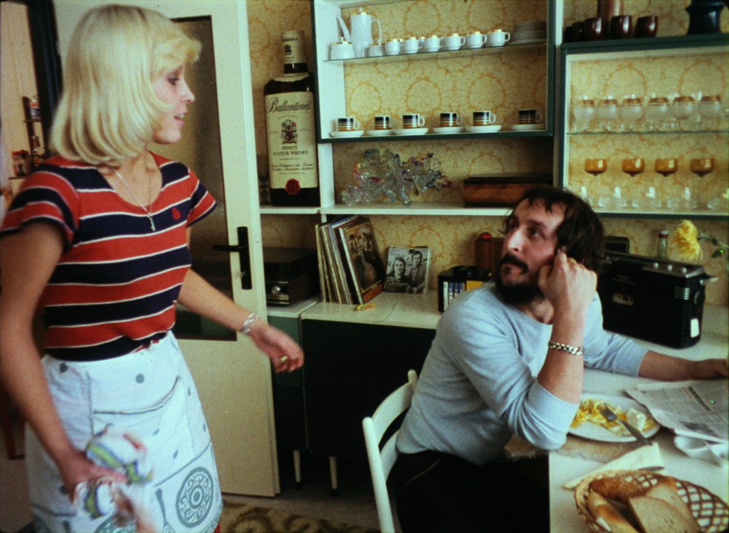 A married couple argue in their apartment in Prefab Story